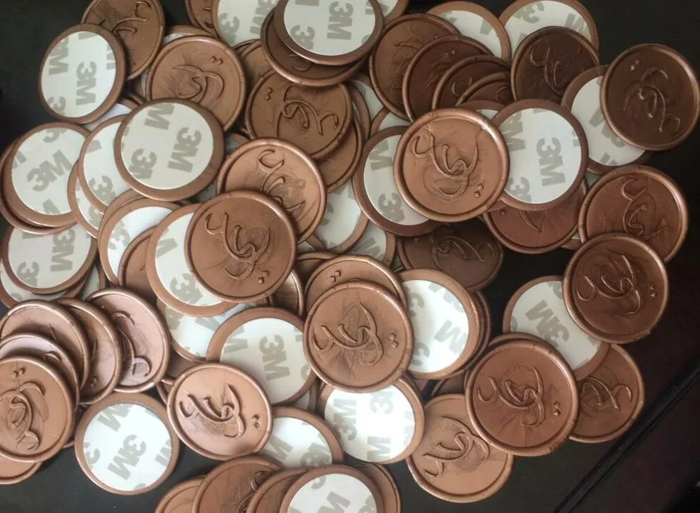 Branded wax seal stickers on luxury product packaging for a UAE brand